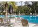 Relaxing community pool area with lounge chairs and tables for residents' enjoyment at 10611 Ladybug Cv, Parrish, FL 34219