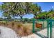 Secure, fenced small dog park featuring green space and a welcome sign at 10611 Ladybug Cv, Parrish, FL 34219