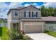 Charming two-story home featuring a two-car garage, neutral color palette, and well-manicured landscaping at 10611 Ladybug Cv, Parrish, FL 34219