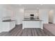 Clean and modern kitchen with stone countertops, stainless steel appliances, and an island at 10611 Ladybug Cv, Parrish, FL 34219