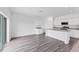 Modern kitchen and living space with granite countertops, stainless steel appliances, and ample natural light at 10611 Ladybug Cv, Parrish, FL 34219