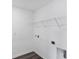 Well-lit laundry room with a wire shelf, hard floors, and utility hookups at 10611 Ladybug Cv, Parrish, FL 34219