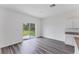 Spacious living room with sliding glass doors leading to the backyard, featuring hardwood floors at 10611 Ladybug Cv, Parrish, FL 34219