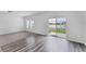 Living room featuring hardwood floors and sliding glass doors with a lake view at 10611 Ladybug Cv, Parrish, FL 34219