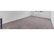 Expansive carpeted living room with ample natural light from the window at 10611 Ladybug Cv, Parrish, FL 34219