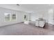 Open-concept living space with hard flooring, large windows, and an island kitchen at 10611 Ladybug Cv, Parrish, FL 34219