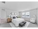 Bright, spacious main bedroom with neutral decor, two windows, and modern furnishings at 10611 Ladybug Cv, Parrish, FL 34219