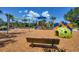Community playground featuring swings, slides, and climbing structures at 10611 Ladybug Cv, Parrish, FL 34219