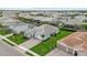 An aerial view captures a neatly landscaped home with a brick driveway surrounded by lush green lawns at 12139 Cranston Way, Bradenton, FL 34211