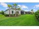 Lush backyard with green lawn and mature landscaping featuring the back of the home at 12139 Cranston Way, Bradenton, FL 34211