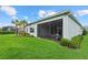 The backyard features a manicured lawn, mature trees, and an outdoor living space at 12139 Cranston Way, Bradenton, FL 34211
