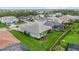A lush green lawn, mature trees, and screened-in patio with a blue swimming pool provide privacy at 12139 Cranston Way, Bradenton, FL 34211