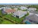 A lush green lawn, mature trees, and screened-in patio are adjacent to a lake in this aerial view at 12139 Cranston Way, Bradenton, FL 34211