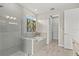 Modern bathroom showcasing a glass-enclosed shower and a separate tub with tile surround at 12139 Cranston Way, Bradenton, FL 34211