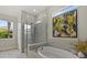 Modern bathroom with a soaking tub, glass-enclosed shower, and natural light at 12139 Cranston Way, Bradenton, FL 34211