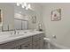 Modern bathroom with double sinks, granite countertops, and a glass-enclosed shower at 12139 Cranston Way, Bradenton, FL 34211