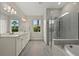 Luxurious bathroom featuring double vanity sinks, glass-enclosed shower, and neutral tones at 12139 Cranston Way, Bradenton, FL 34211