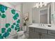 Stylish bathroom with a patterned shower curtain, gray vanity, and modern fixtures at 12139 Cranston Way, Bradenton, FL 34211