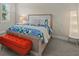 Cozy bedroom with a comfortable bed and an orange cushioned bench at 12139 Cranston Way, Bradenton, FL 34211