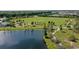 Scenic aerial view of community park near lake featuring playground and picnic area at 12139 Cranston Way, Bradenton, FL 34211