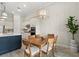 Cozy dining area with wood table, decorative lighting fixture, and view of the kitchen at 12139 Cranston Way, Bradenton, FL 34211