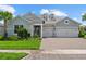 Attractive home with a lush green lawn, brick driveway, and a convenient two-car garage at 12139 Cranston Way, Bradenton, FL 34211
