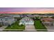 Charming single-Gathering home with a well-manicured lawn, mature palm trees, and a two-car garage at sunset at 12139 Cranston Way, Bradenton, FL 34211