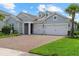 Beautiful single-Gathering home featuring a brick driveway and a two-car garage at 12139 Cranston Way, Bradenton, FL 34211