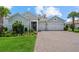 Charming one-story home with a well-manicured lawn, beautiful landscaping, and a three-car garage at 12139 Cranston Way, Bradenton, FL 34211