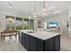 Open-concept kitchen with a large island, pendant lighting, and seamless flow into the living area at 12139 Cranston Way, Bradenton, FL 34211