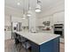 Bright kitchen with stainless steel appliances, large island with seating, and modern pendant lighting at 12139 Cranston Way, Bradenton, FL 34211