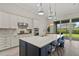 Well-designed kitchen featuring a center island with bar seating, stainless appliances, and ample natural light at 12139 Cranston Way, Bradenton, FL 34211