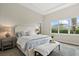 Serene main bedroom with a large window, a cozy rug, and neutral decor at 12139 Cranston Way, Bradenton, FL 34211