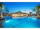 Stunning pool area with crystal-clear blue water, palm trees, lounge seating, and beautiful landscaping at 12139 Cranston Way, Bradenton, FL 34211