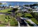 Overhead view of the marina entrance, lined with palm trees, lush grass and parking spaces, leading to the docks at 1505 43Rd Avenue W Dr, Palmetto, FL 34221