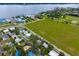 Aerial view of a neighborhood with homes, lush trees, roads, and a bay in the background at 1505 43Rd Avenue W Dr, Palmetto, FL 34221