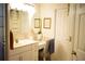 Bright bathroom featuring a vanity with a sink, a chair, mirror and a doorway at 1505 43Rd Avenue W Dr, Palmetto, FL 34221
