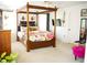 Spacious bedroom with a four-poster bed, carpet, and comfortable seating at 1505 43Rd Avenue W Dr, Palmetto, FL 34221