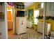 Cheerful bedroom with yellow walls, carpet floors, and a doorway leading to the bathroom at 1505 43Rd Avenue W Dr, Palmetto, FL 34221