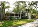Charming two-story home featuring a screened porch and attached two-car garage surrounded by lush greenery at 1505 43Rd Avenue W Dr, Palmetto, FL 34221
