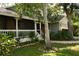 Inviting front porch and meticulously landscaped yard surrounded by beautiful Florida landscaping at 1505 43Rd Avenue W Dr, Palmetto, FL 34221