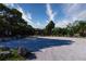 Expansive parking lot with a wooden gazebo and dense surrounding trees at 1505 43Rd Avenue W Dr, Palmetto, FL 34221