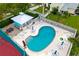 Aerial view of community pool with lounge chairs and umbrellas at 1505 43Rd Avenue W Dr, Palmetto, FL 34221