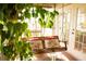Charming porch swing featuring decorative pillows on a brick floor with lush plants at 1505 43Rd Avenue W Dr, Palmetto, FL 34221