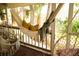 Relaxing porch with hammock, hanging chairs, and wooded floor for a cozy outdoor experience at 1505 43Rd Avenue W Dr, Palmetto, FL 34221
