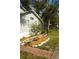 A well-maintained side yard featuring a brick pathway, neatly arranged landscaping and a vibrant flower garden at 1505 43Rd Avenue W Dr, Palmetto, FL 34221