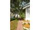 Brick pathway leading through a side yard with tidy landscaping, enhancing the property's charm at 1505 43Rd Avenue W Dr, Palmetto, FL 34221