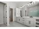 Modern bathroom with double vanity, large mirror, quartz counters, and ample storage at 1605 Landfall Dr, Nokomis, FL 34275