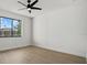 Bedroom features a ceiling fan and a window overlooking the exterior at 1605 Landfall Dr, Nokomis, FL 34275