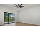 Bedroom features sliding glass doors that lead to an outdoor patio area and ceiling fan at 1605 Landfall Dr, Nokomis, FL 34275